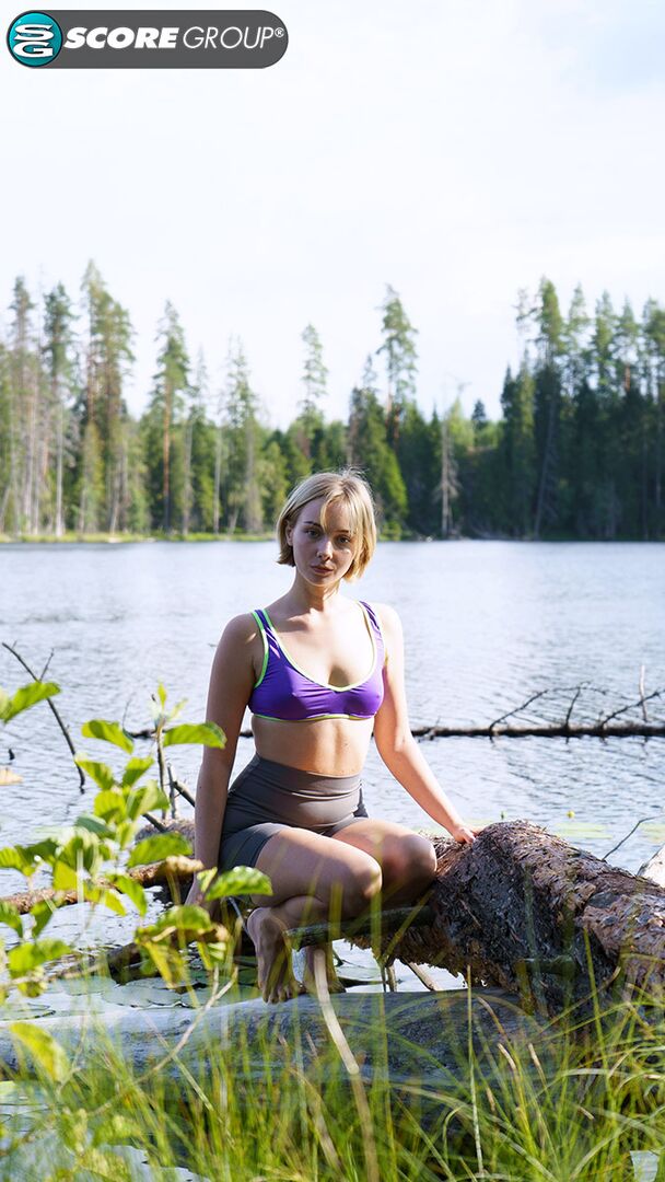 Outdoorsy blonde with cute, perky tits drops her yoga pants and spreads her pussy next to a lake.