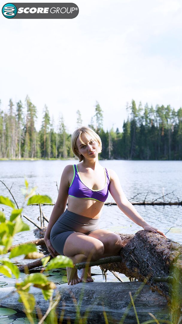 Outdoorsy blonde with cute, perky tits drops her yoga pants and spreads her pussy next to a lake.