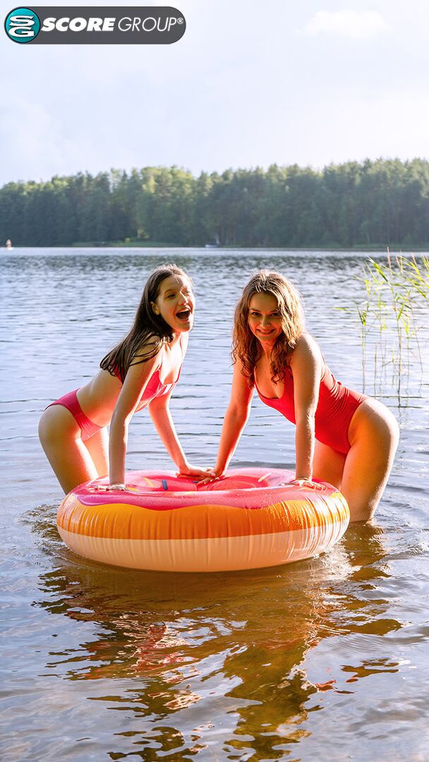 Margo Von Teese and Simona splash each other in their bikinis in a lake before eating each other out on the beach.