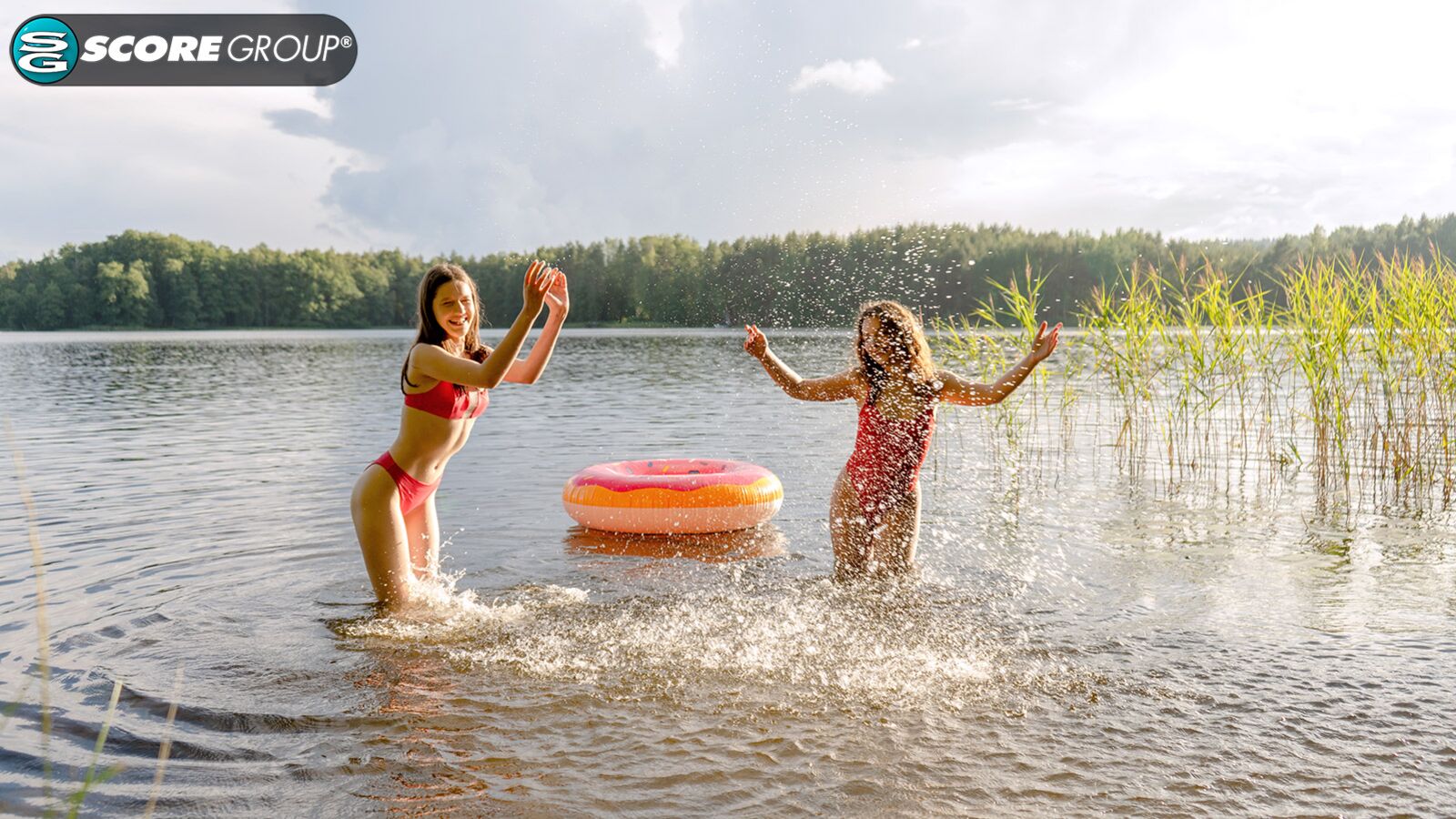 Margo Von Teese and Simona splash each other in their bikinis in a lake before eating each other out on the beach.