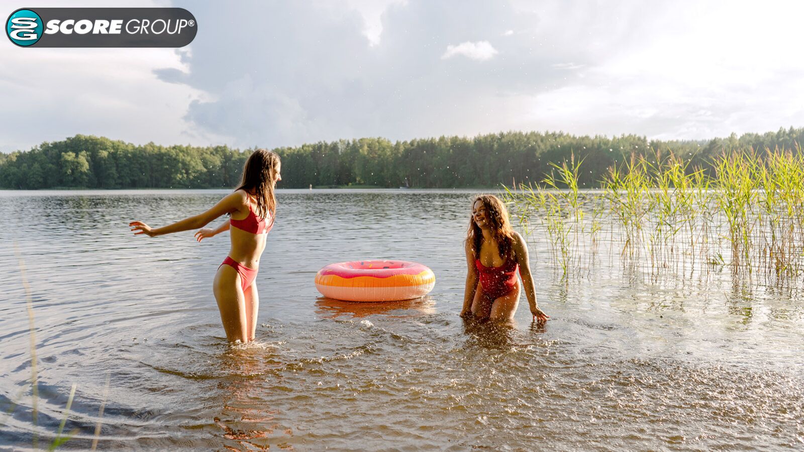 Margo Von Teese and Simona splash each other in their bikinis in a lake before eating each other out on the beach.