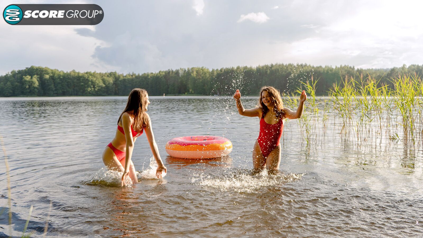 Margo Von Teese and Simona splash each other in their bikinis in a lake before eating each other out on the beach.