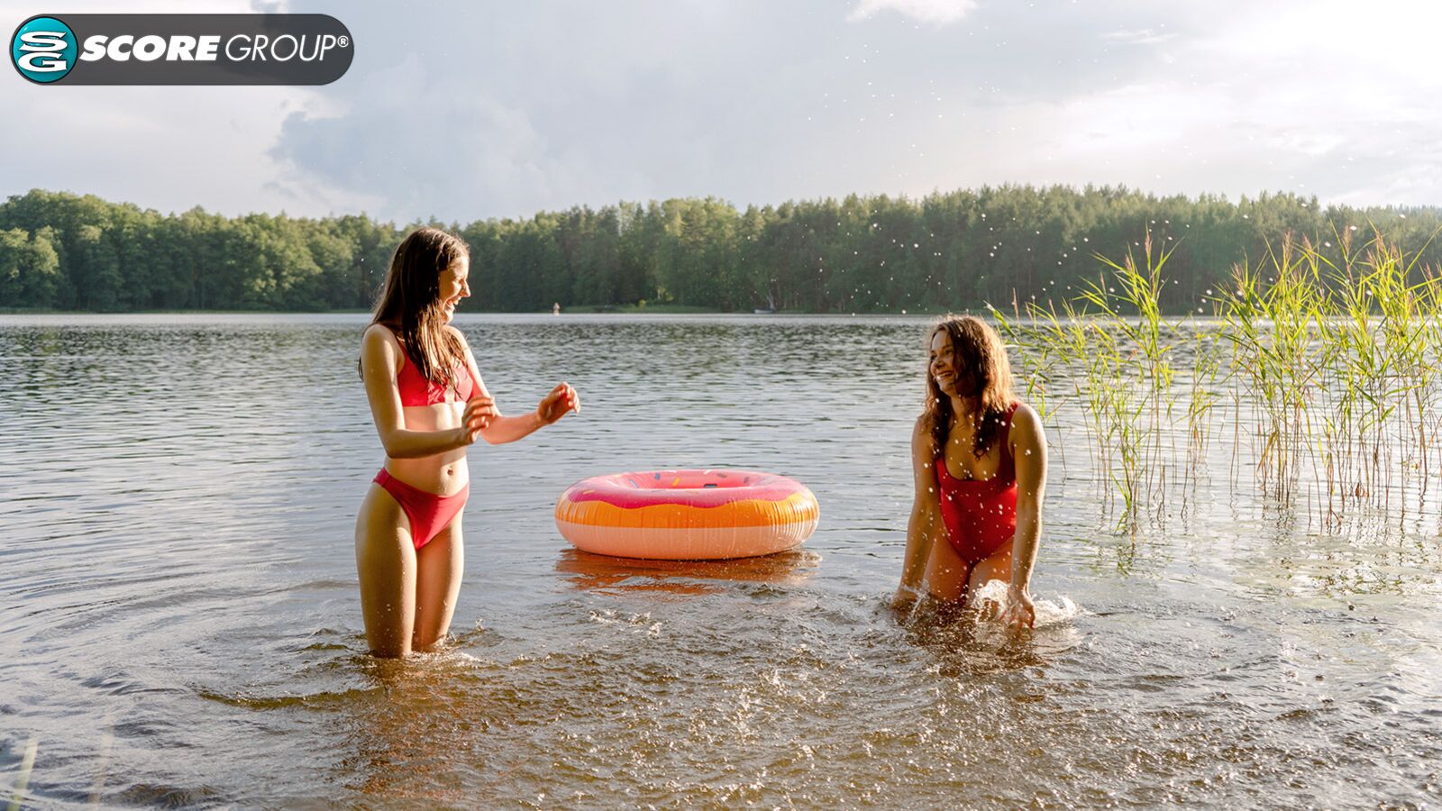 Margo Von Teese and Simona splash each other in their bikinis in a lake before eating each other out on the beach.