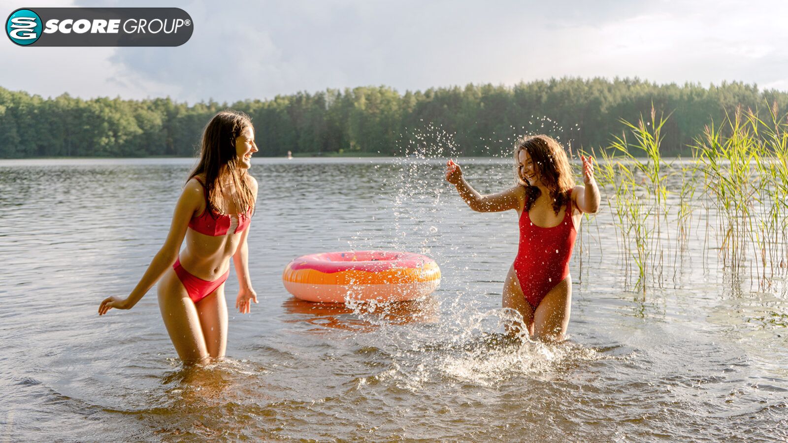 Margo Von Teese and Simona splash each other in their bikinis in a lake before eating each other out on the beach.