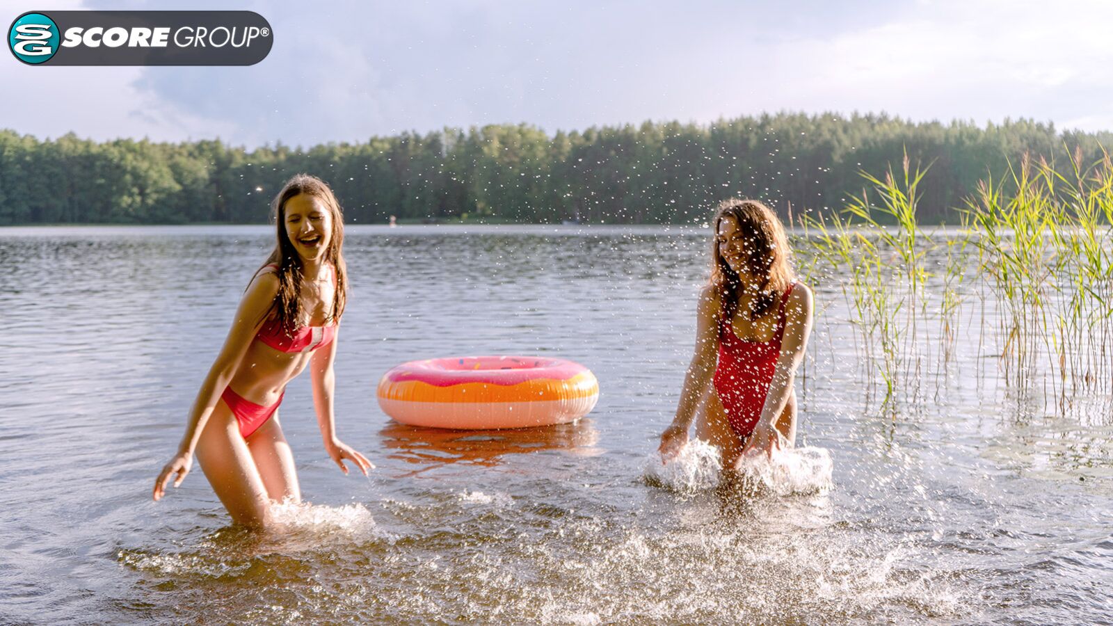 Margo Von Teese and Simona splash each other in their bikinis in a lake before eating each other out on the beach.