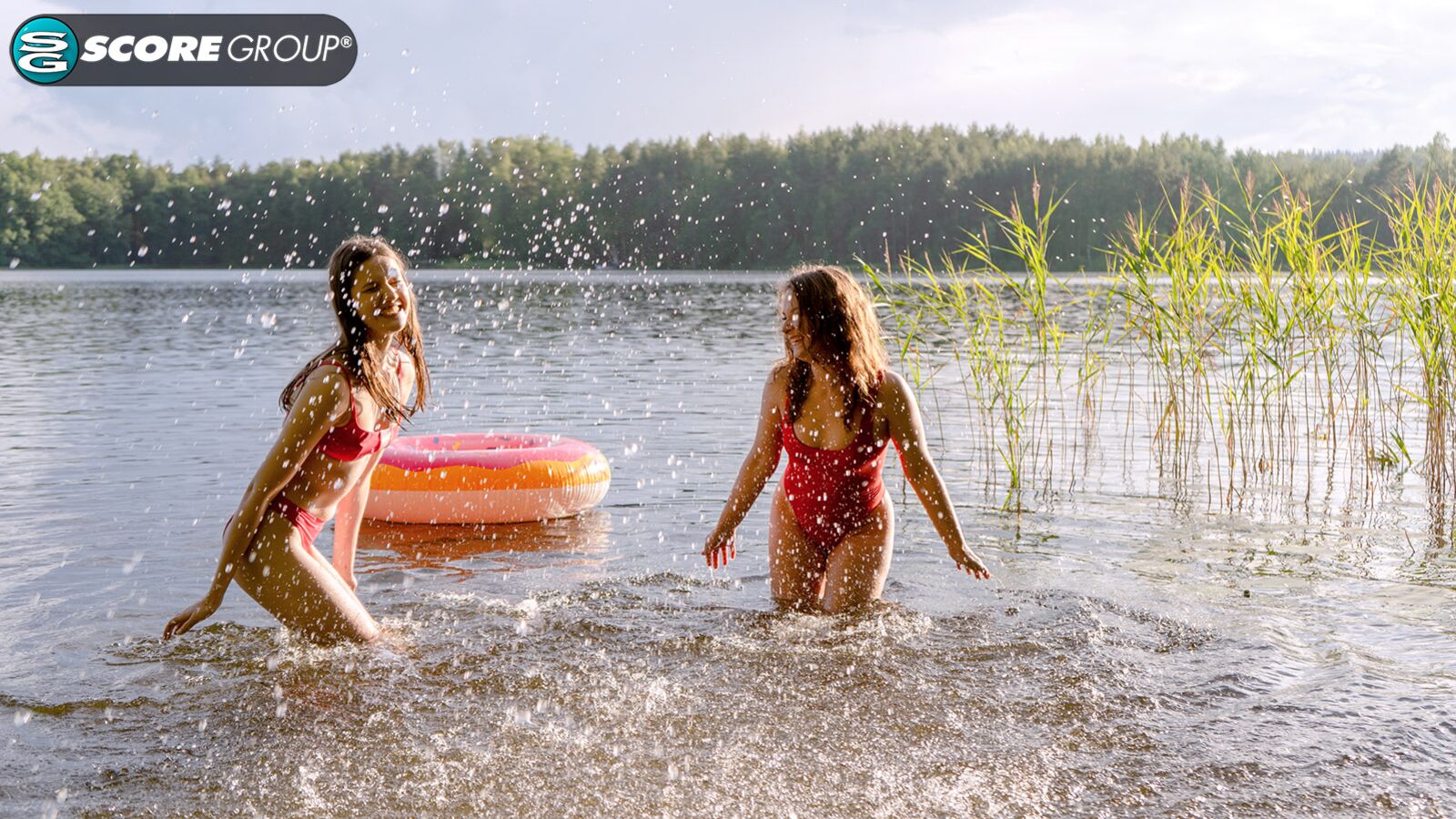 Margo Von Teese and Simona splash each other in their bikinis in a lake before eating each other out on the beach.