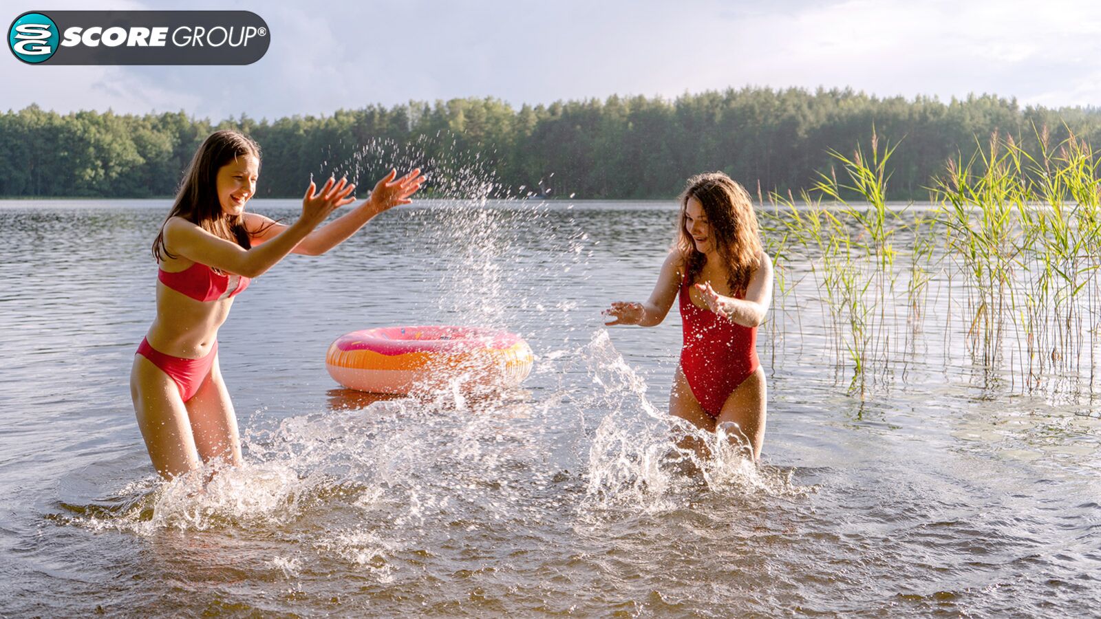 Margo Von Teese and Simona splash each other in their bikinis in a lake before eating each other out on the beach.