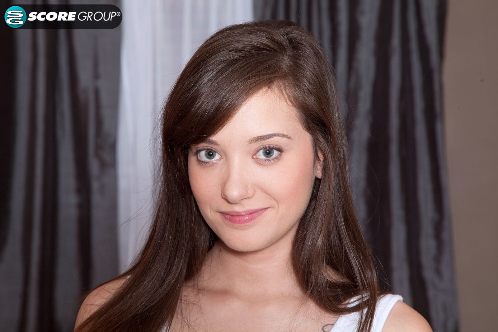 Gia Page is a skinny brunette with a cute smirk and a pink pussy.