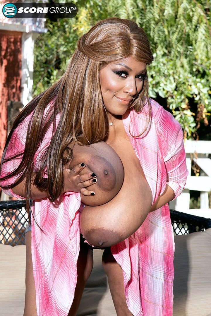 Africa gets out her giant tits outdoors and plays with her very pink pussy