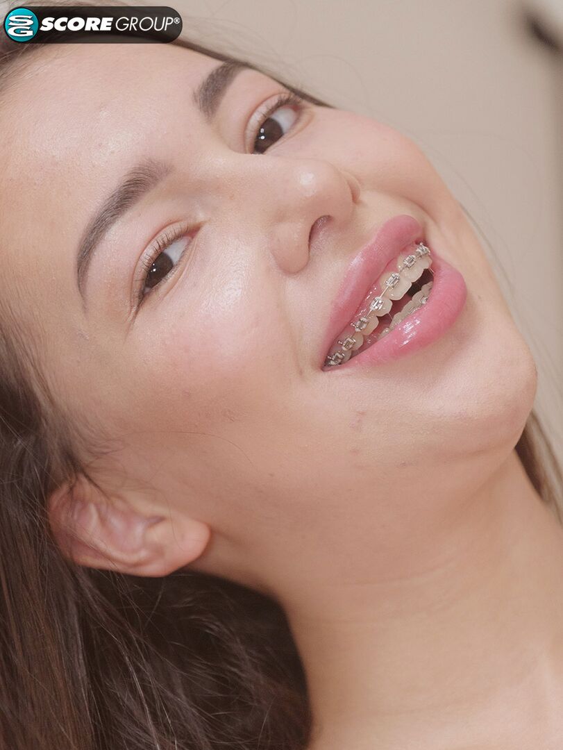 Lola Li, 18, is a brace-face with perfect, perky knockers and a deliciously juicy pussy that she slams with a big dildo.