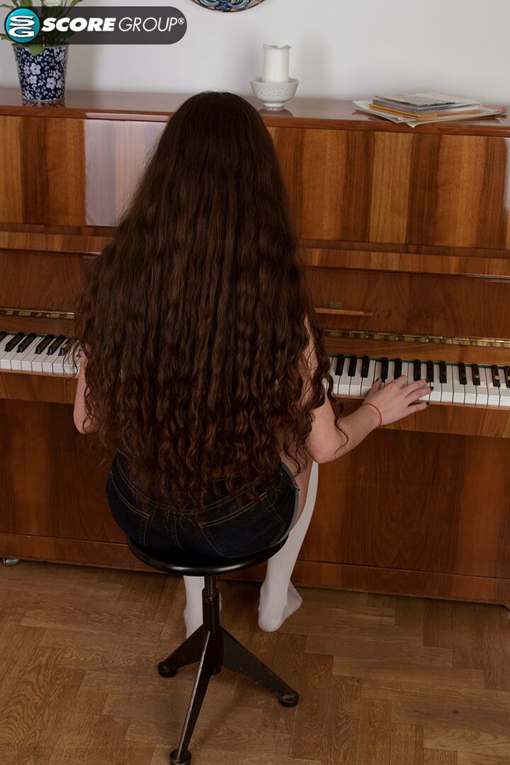 Adel, a cutie with long, flowing brunette hair, plays the piano and then fingers her tight slit.