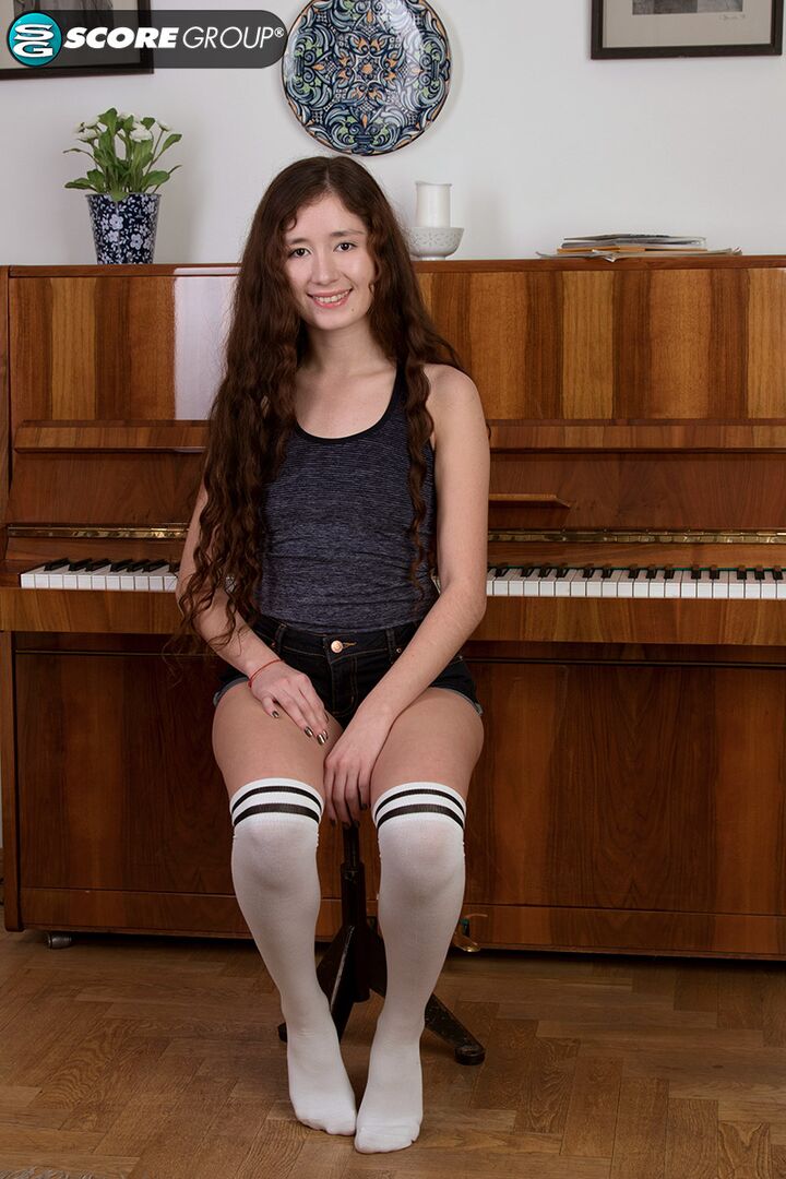 Adel, a cutie with long, flowing brunette hair, plays the piano and then fingers her tight slit.