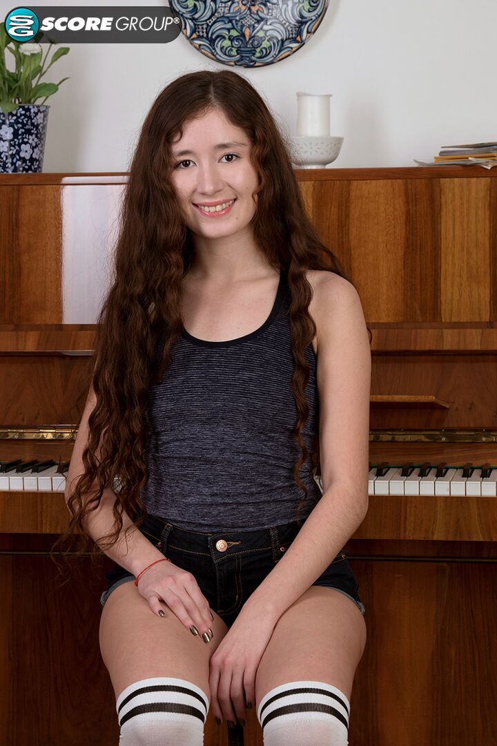 Adel, a cutie with long, flowing brunette hair, plays the piano and then fingers her tight slit.