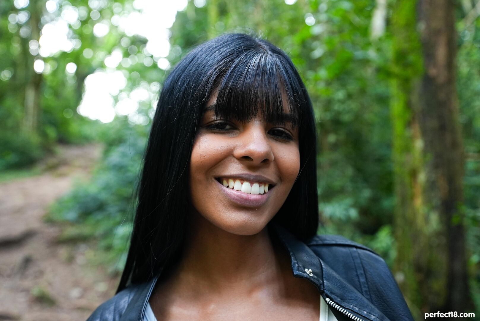 Brunette beauty relaxes in forest clearing