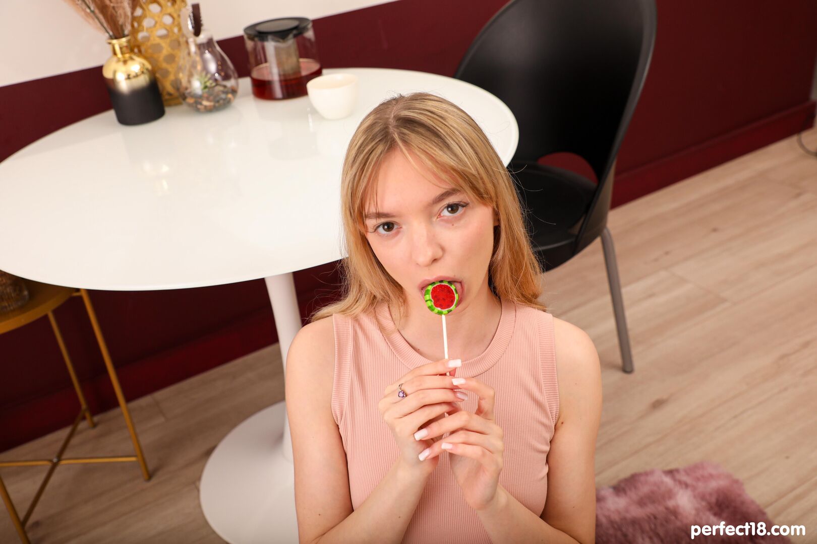 Intimate moment of a slim blonde on the soft carpet