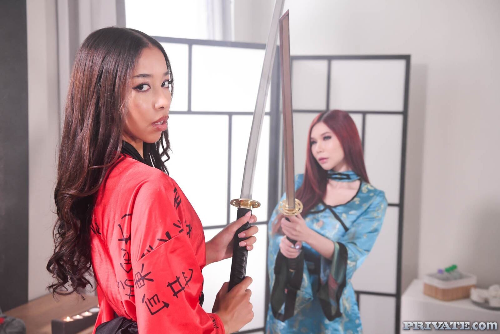 Asians Lia Lin and April Máxima, and their masseur's katana