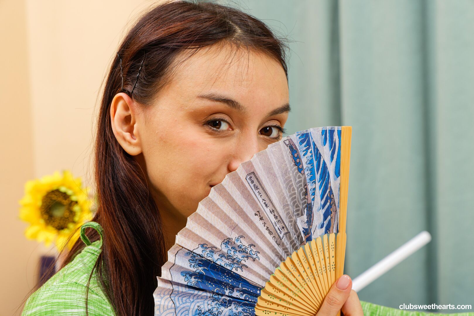 Ashly rabbit cools herself with a fan