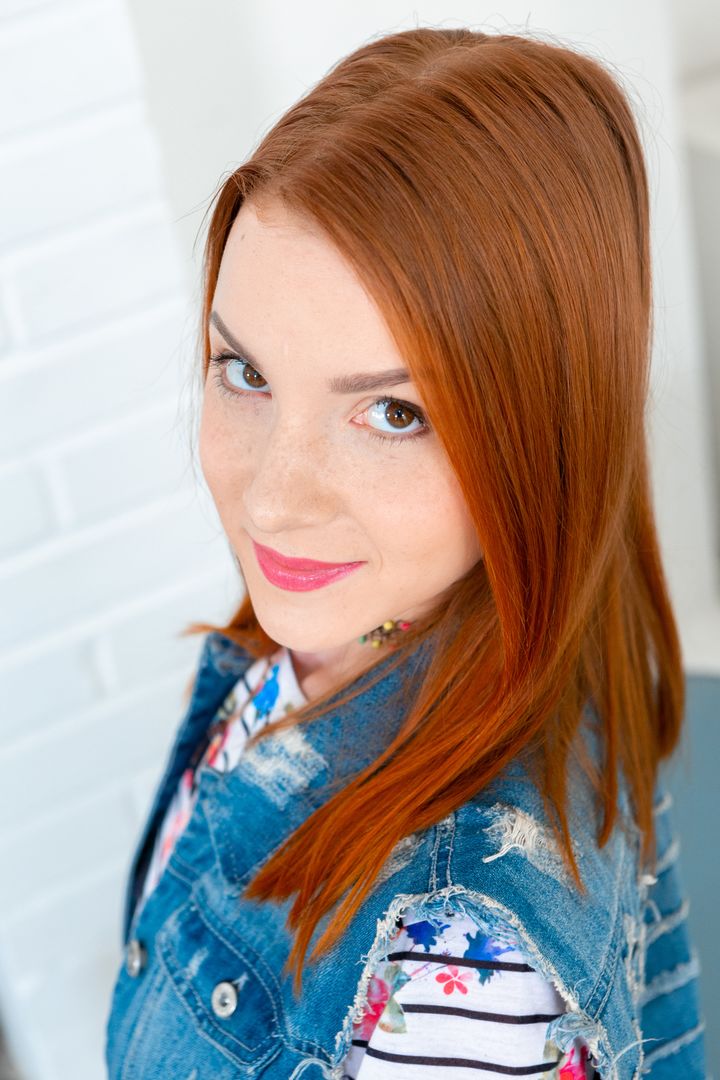 Red-haired cutie rides photographer's dick