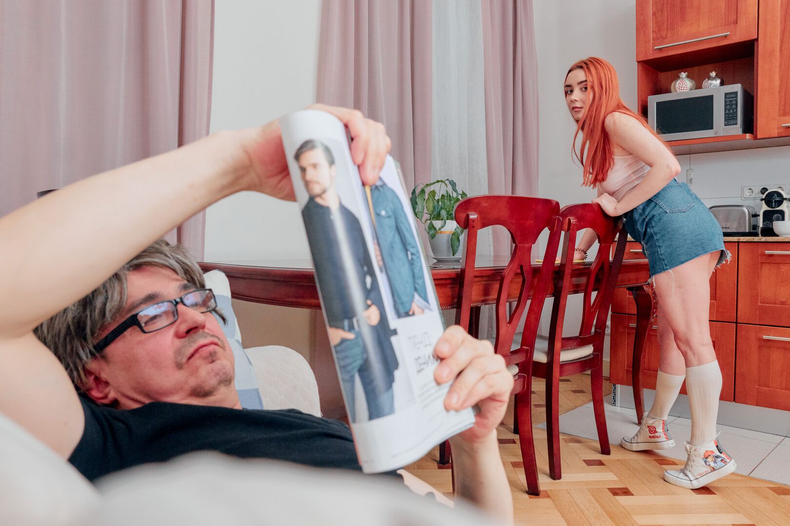 Ginger cutie seduces a grey-haired man
