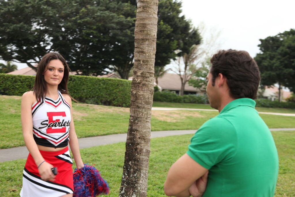 Cheerleader Monica Guides Her Pussy Onto A Stiff Cock