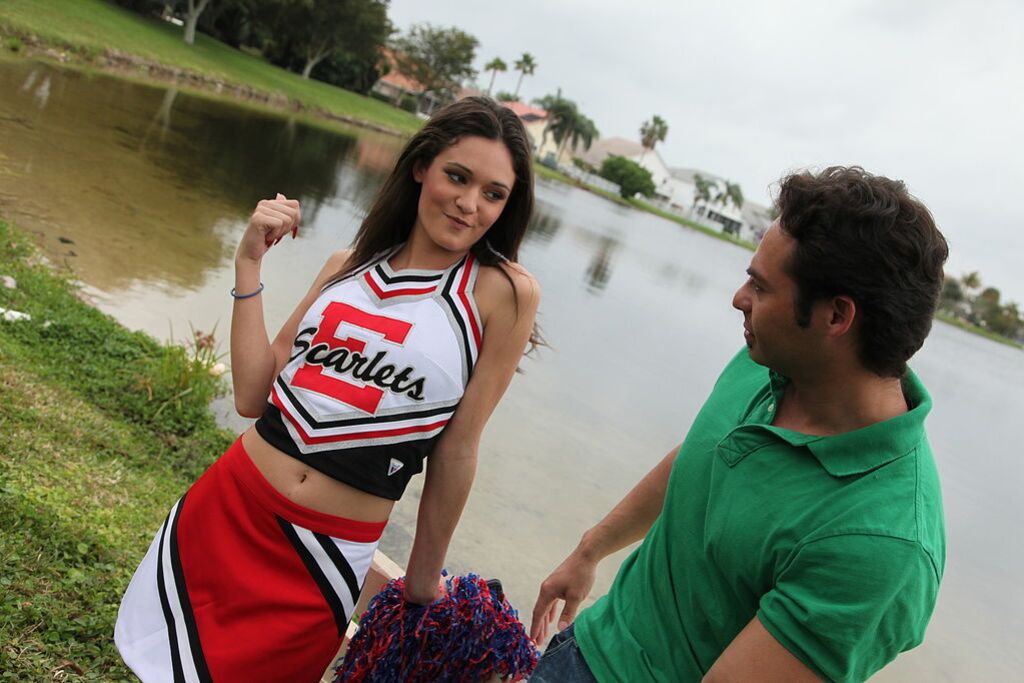 Cheerleader Monica Guides Her Pussy Onto A Stiff Cock